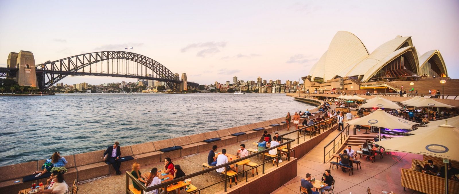 Panoramic view of Sydney Opera House and Harbour Bridge from the Opera Bar, Australia.